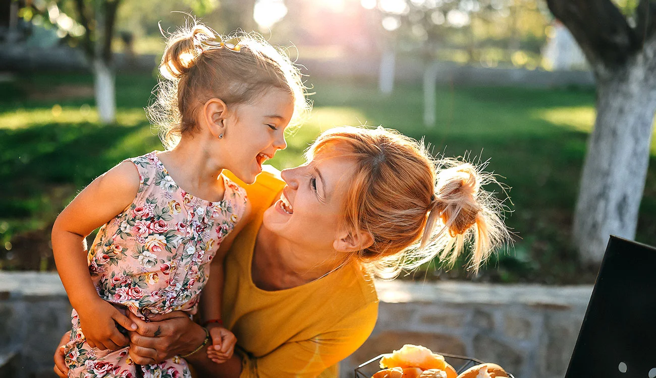 Parent and child smiling together